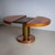 Round extendable table featuring an exceptional bronze pedestal base with a textured surface, adding a distinctive touch...