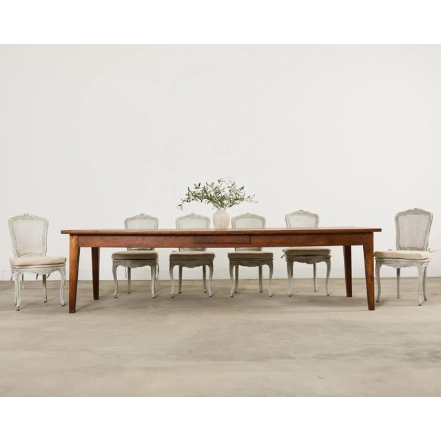 Quintessential 19th century country French provincial style farmhouse table made on a grand scale measuring nearly 10 feet...