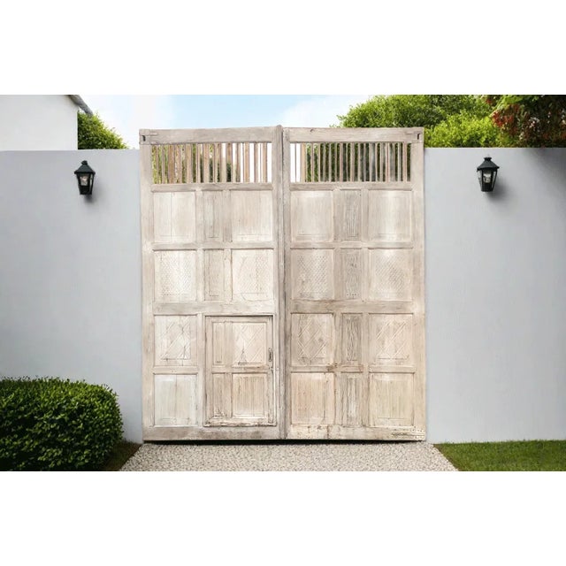 Built as a palace entrance, this pair of massive antique double doors were made from teak. This pair of large 19th century...