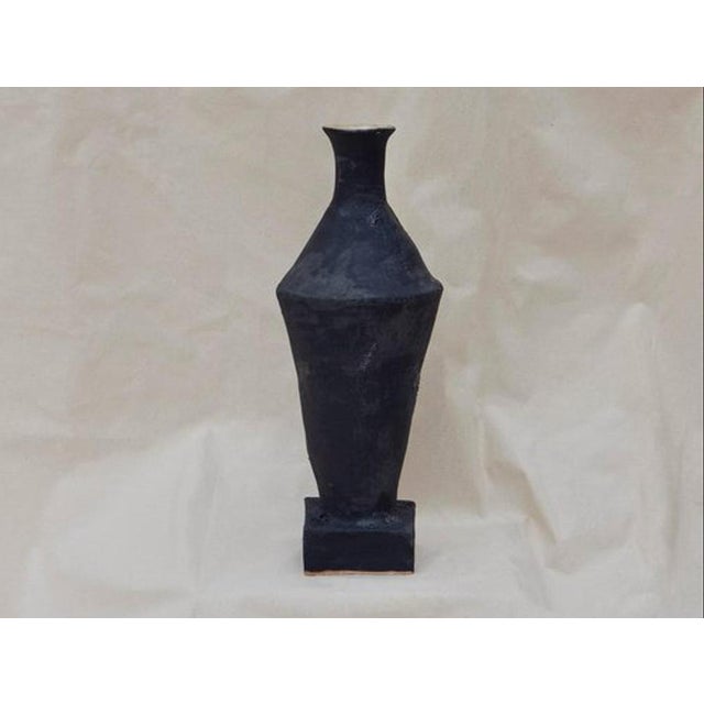 Small open water vessel by oikos estudio x matter edit handmade dimensions: d 10 x w 10 x h 43 cm materials: clay and...