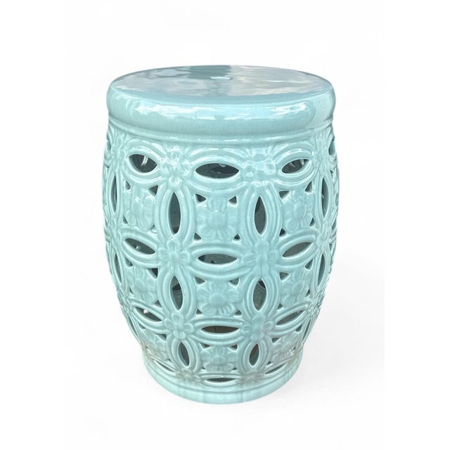 The Duluth Garden Stool is a ceramic garden stool with a barrel form and an interlocking rings pierced pattern in a high-...