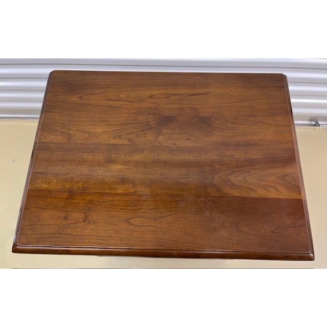 L & JG Stickley cherry wood nightstand has dove tailed joints, ogee feet and brass hardware. Made in Fayetteville, NY,...