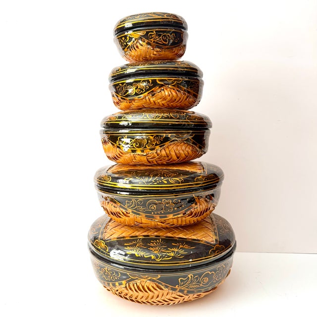 Beautiful set of Five round wicker baskets with lids and black lacquered details! Made in graduating sizes to nest within...