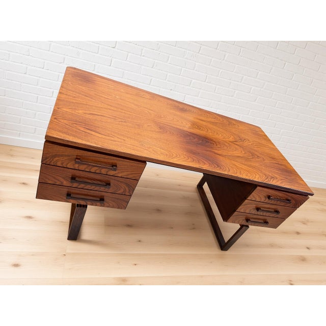 This elegant rosewood desk, designed by Henning Jensen and Torben Valeur, showcases beautiful detailing and solid...