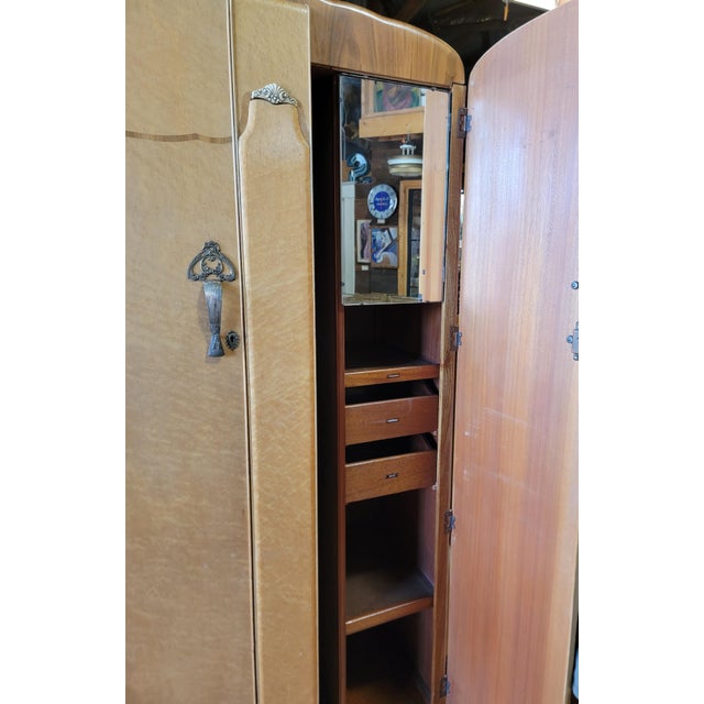 A 2 door birds-eye maple Art Deco style armoire with a fitted interior. Featuring 2 sliding drawers, clothes and tie...