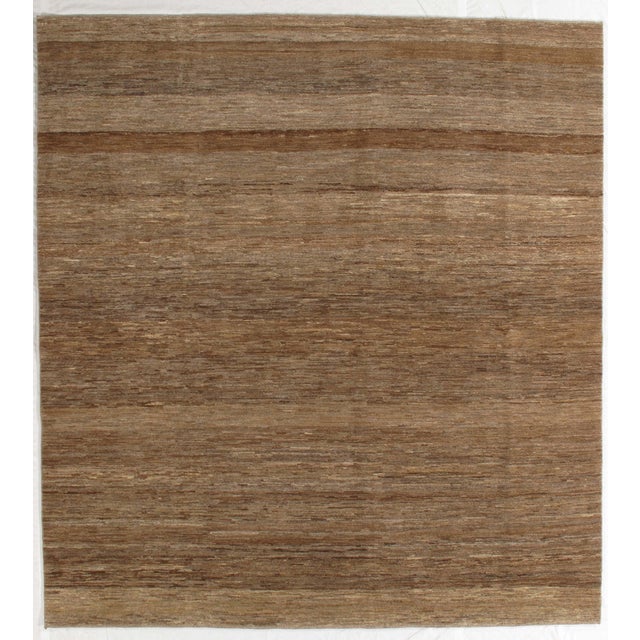 Vintage hand-knotted Persian Fine Lori Gabbeh rug featuring a warm, earthy field with subtle tonal striations and organic...