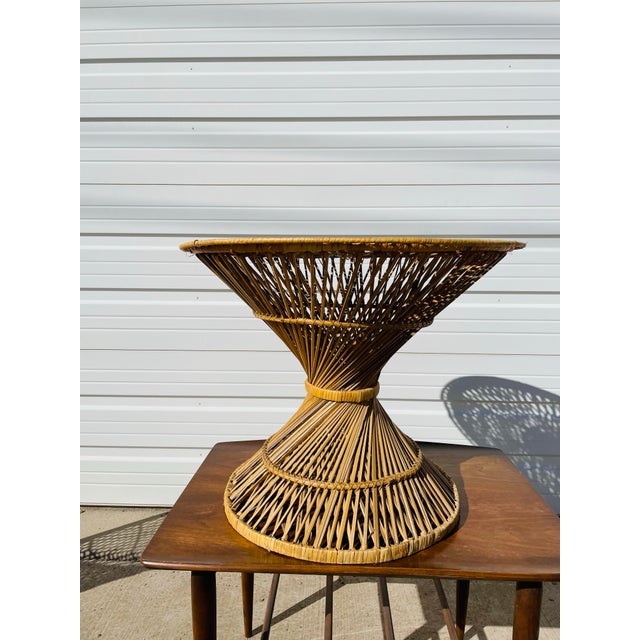 Vintage 1970s spun wicker rattan side table. Beautiful design with unique shape. Perfect for any outdoor space or as a...