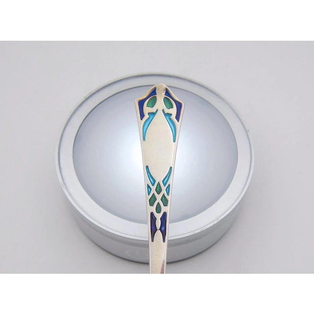 Three early 20th century American sterling silver utensils with vivid plique-à-jour enamel decoration. All three specialty...