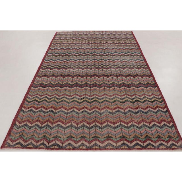 This vintage 6x10 Turkish rug is a striking hand-knotted wool weaving dating to circa 1950–1960. The piece features an...