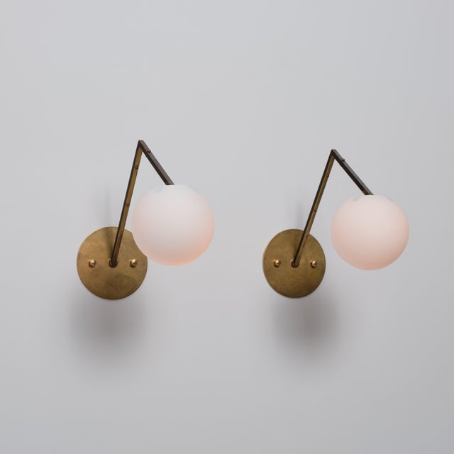 Pair of italian wall sconces dating from the 1950s, characterized by a distinctive geometric mid-century modern design....
