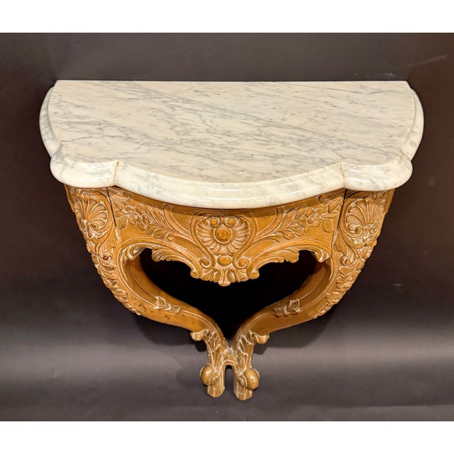 This elegant console table is hand carved from beechwood and finished in a soft whitewashed tone that enhances the depth...
