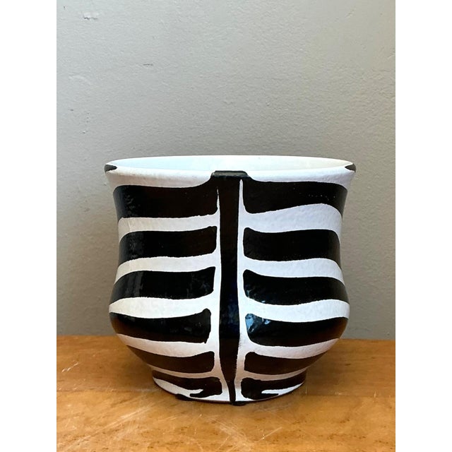 Exuding graphic allure and mid-century elegance, this vintage Italian ceramic cache pot makes a striking statement in any...