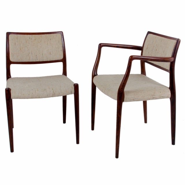 Set of four Niels Otto Møller rosewood dining chairs. One model 65 armchair and three model 80 side chairs. Original tweed...