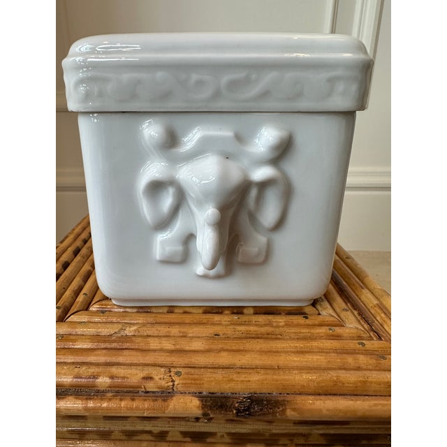 Beautiful Vintage Porcelain Box Featuring Stylized Elephant Trunk Handles. Top of box with raised design of peacock among...