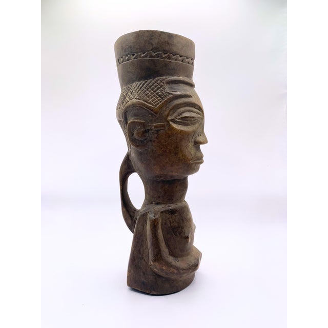 Beautifully hand-carved African tribal art piece. This striking item features an elongated female bust topped with a...