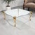 An exceptional Hollywood Regency coffee table featuring four monumental cast metal legs supporting a custom-shaped thick...
