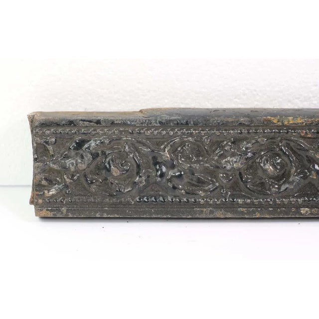 Turn of the century cast iron architectural trim piece. This is painted black. The manufacturer and exact date of creation...