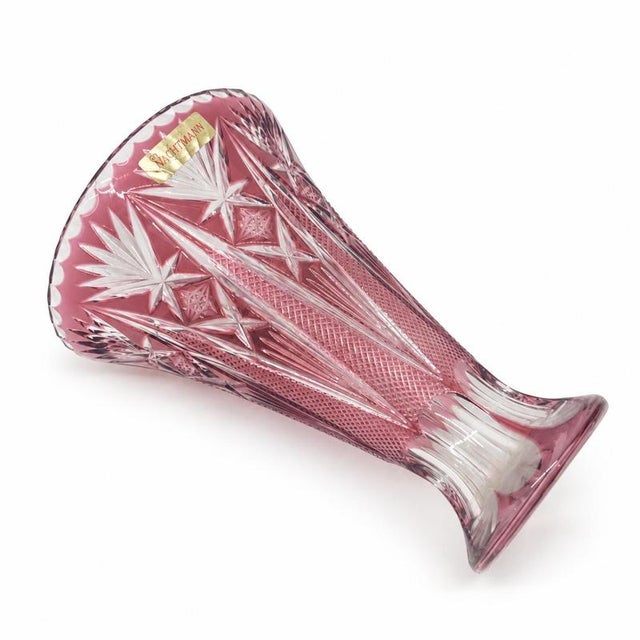 Heavy bell-shaped vase, with star, fan, lozenge and lanceolate point cuts; original label. Cataloguing: period c....