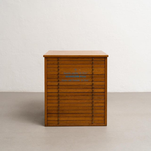 Authentic wooden display cabinet from Sennelier Paris, circa 1990, showcasing an assortment of colorful pastel paints....