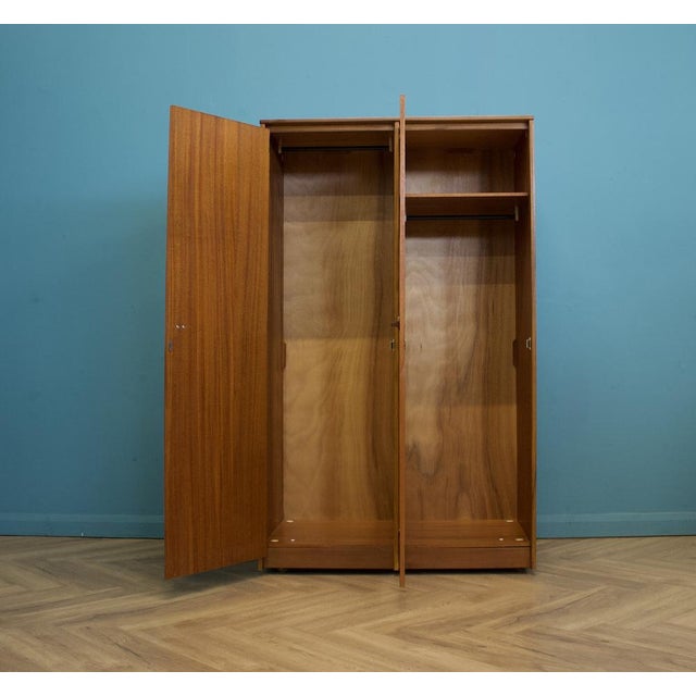 A freestanding double door teak wardrobe from Stag for the Cantata range - designed by John and Sylvia Reid. Made during...