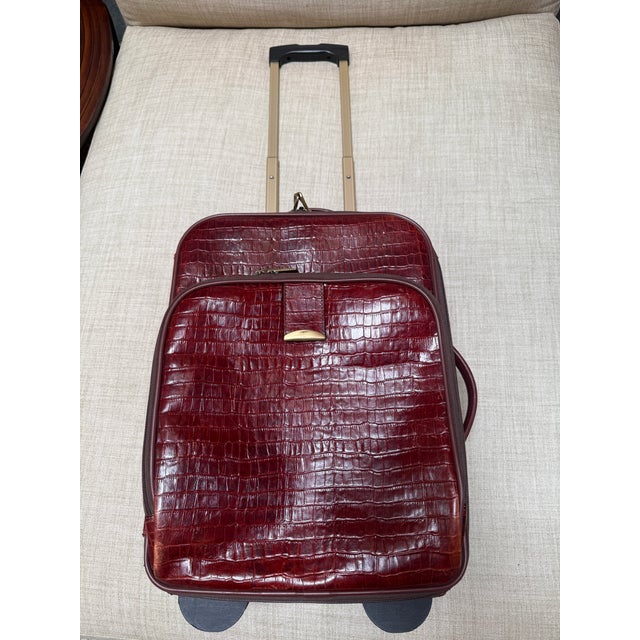 Design Plus Gallery presents a Maroon Leather Trolley Luggage Piece of Embossed Printed Crocodile. A staple for any well-...