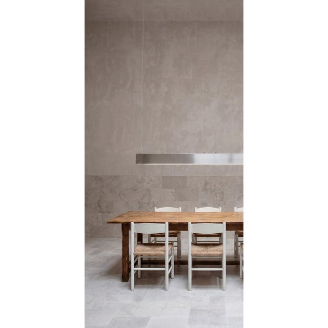 An imposing 19th-century rustic dining table, crafted from beech wood, a striking piece that reflects the solidity and...