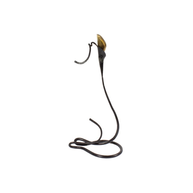 A hand-foraged iron and brass calla lily candle holder by the American artist and blacksmith Jack Brubaker. This piece...
