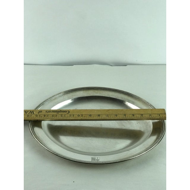 Heavy antique silver armorial platter in an pointed oval shape. charming armorial crest hand engraved on the side of...