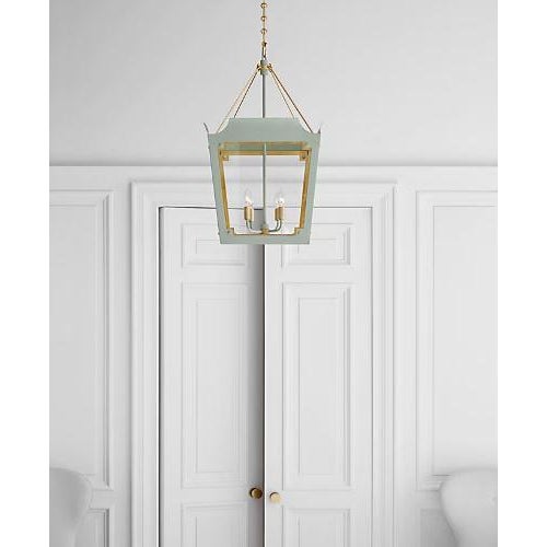 Designer Julie Neill Caddo Medium Lantern in Celadon with Gild Finish. Specifications: Height: 32" Width: 19" Canopy: 5.5"...