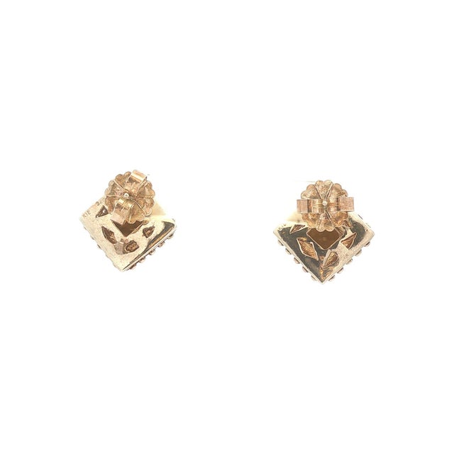 A striking pair of stud earrings featuring a geometric design. Crafted with 18k gold and sterling silver. Accented with...