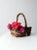A vintage rustic woven basket crafted from natural twigs, showcasing a timeworn, organic character. The form is sturdy and...