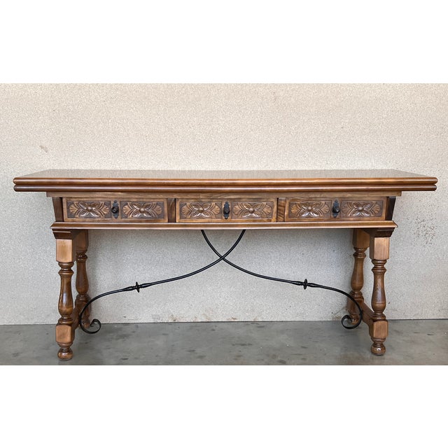 About the Item Early 20th century Spanish console fold out table with iron stretcher & three drawers. A beautiful early...