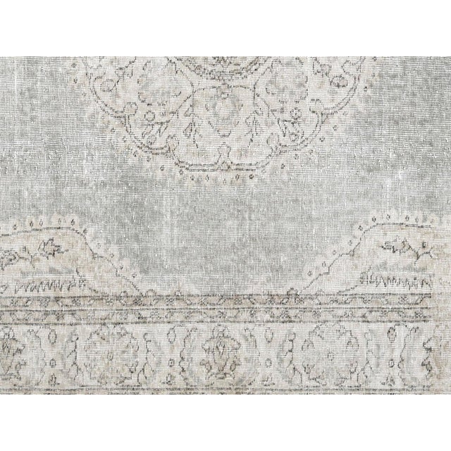 Handwoven wool-on-wool Oushak rug from vintage Turkey, measuring 6'9" x 10'. Originating from the storied weaving...