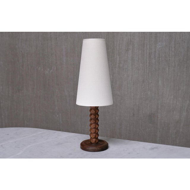 This rare table lamp was produced in France during the 1950s. The rustic yet elegant design is attributed to the renowned...
