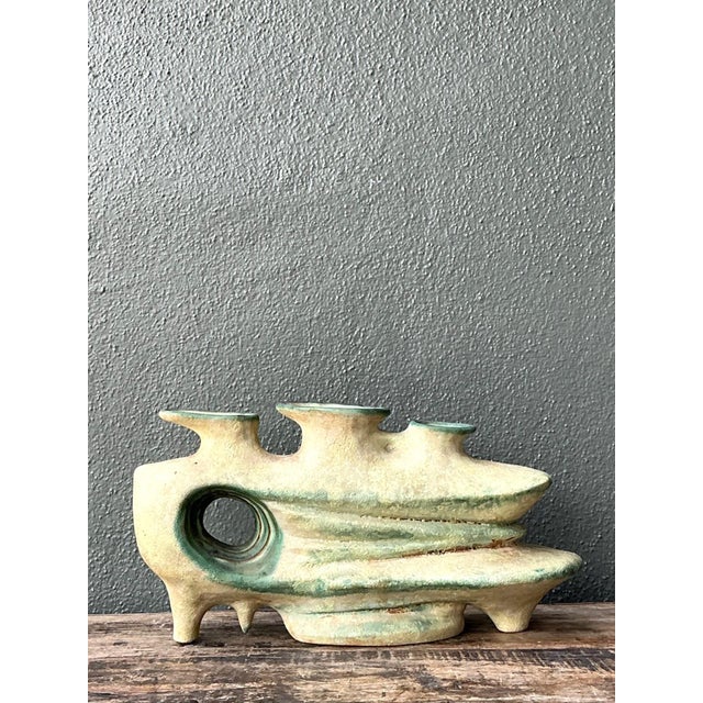 Celebrating the sculptural experimentation of the mid-20th century, this vintage organic form pottery sculpture is a...