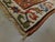 This antique Caucasian Genje Gallery rug features a striking geometric diagonal striped field patterned with stylized...