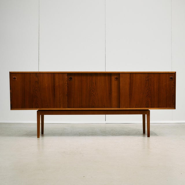 This low sideboard pairs beautiful materials with thoughtful design. The body is crafted from richly figured rosewood...