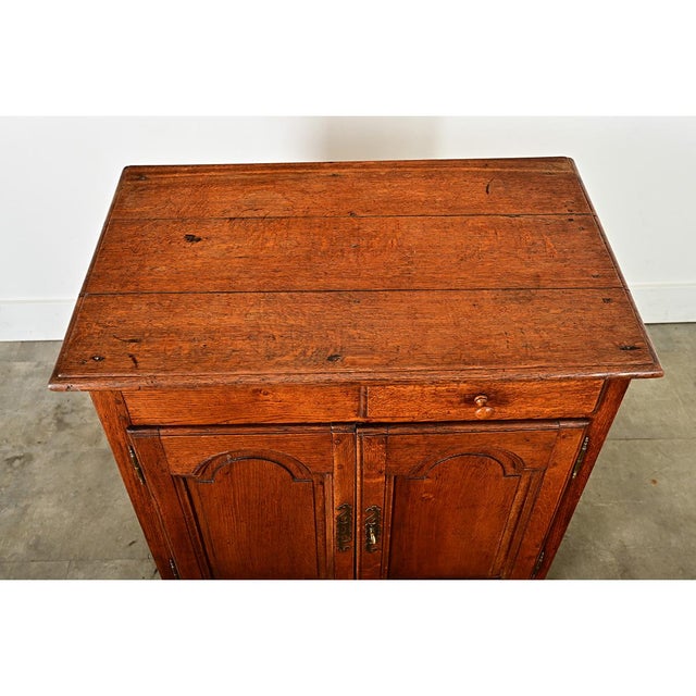 A charming 19th century solid oak petite buffet, exhibiting French Provincial flair and creativity which gives personality...