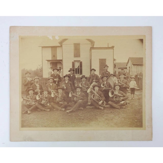 Antique circa 1900 photograph of brass band with drums and little boy on the cymbal. Unsigned, location unknown. Unframed,...
