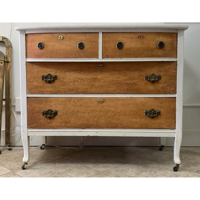 Beautiful vintage solid wood dresser featuring a graceful curved front, warm natural wood drawer fronts, and a white...