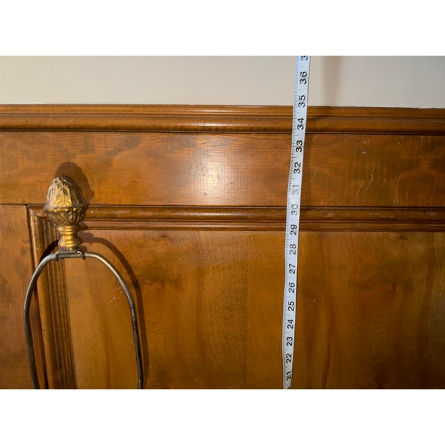 Neoclassical lamps characterized by their urn-shaped bodies and decorative handles finished with a combination of mottled...