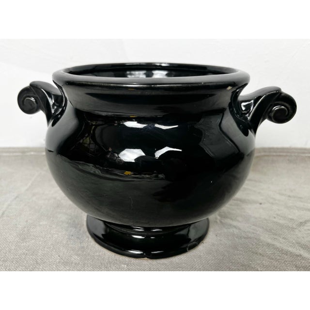 Vintage mid century McCoy black ceramic urn. Low round shape with art deco curled handles. Made in USA.
