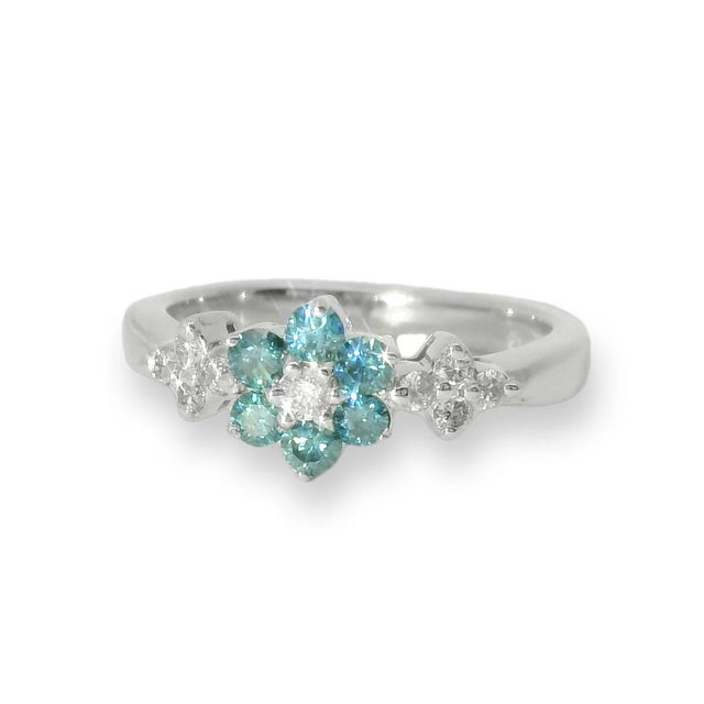 This exquisite estate ring features a delicate floral design crafted in 14K white gold. Adorned with 6 brilliant round...