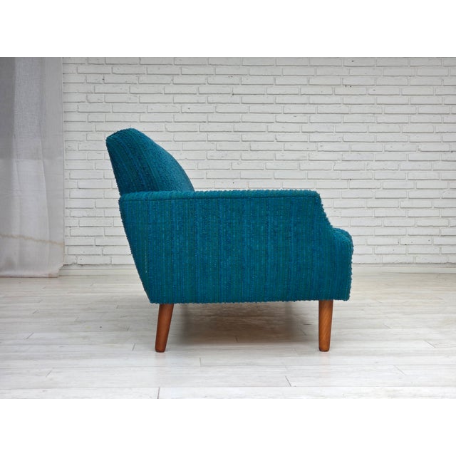 1970s, Danish 3-seater sofa. Original blue/green furniture wool, teak wood legs, springs in the seat cushions. Original...