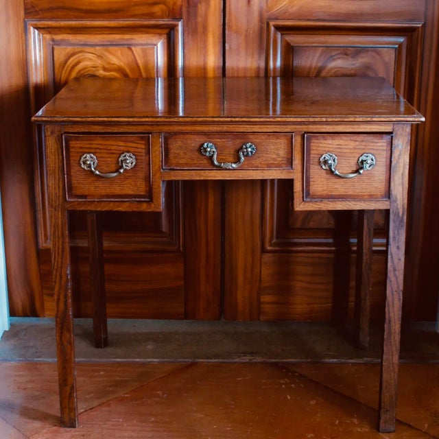 A versatile English country lowboy with three cross banded drawers. The top is very handsome quarter sawn oak, nicely...