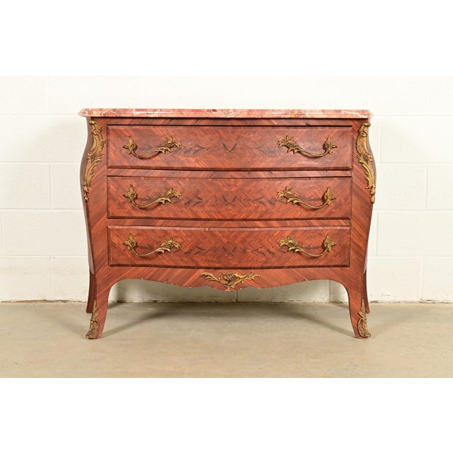 A gorgeous French Provincial Louis XV style bombay form commode, dresser, or chest of drawers In the manner of Paul...