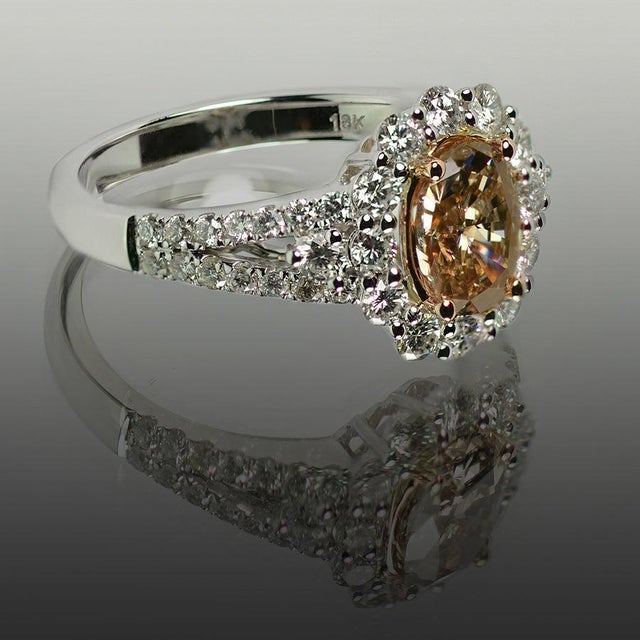 18k White gold ring with 1.26 carat fancy yellow brown diamond and 0.96 carats of round white diamonds. 5.17 grams size 7