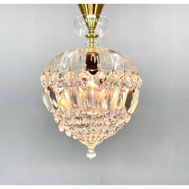 Beautiful samll vintage crystal chandelier with brass canopy. Made in former czechoslovakia in the 1970's. There are some...