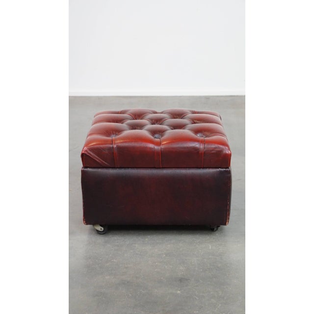 Red cow leather square chesterfield ottoman/storage ottoman. A cowhide footstool, also called an ottoman, turns your...