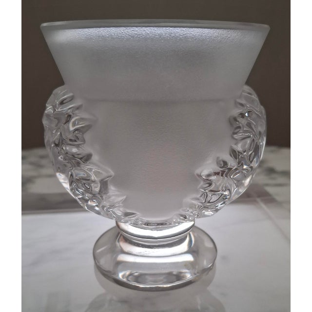 This vintage Lalique Saint Cloud crystal flower vase is a classic mid-century modern design featuring a conical frosted...